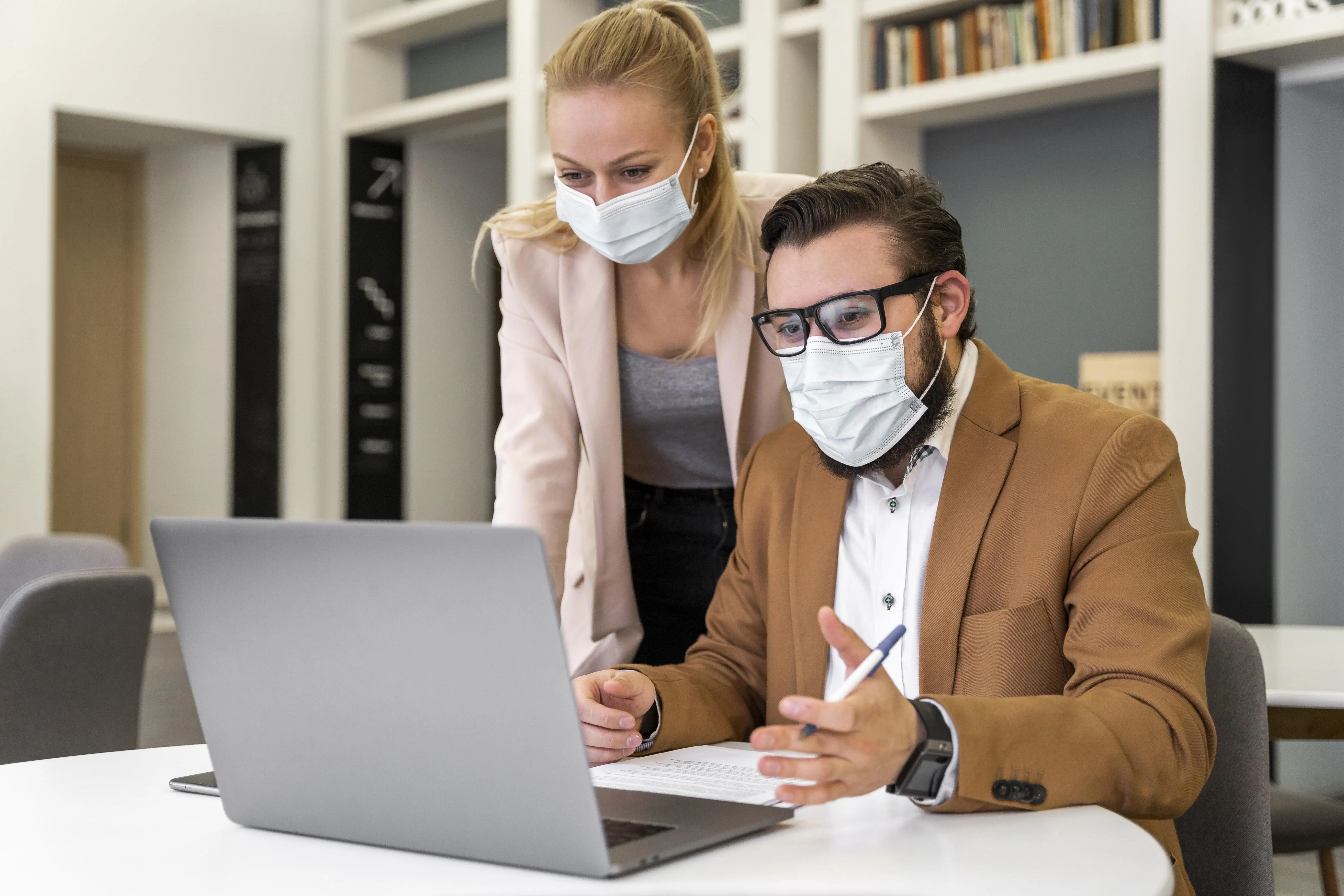 Medium shot of colleagues wearing masks