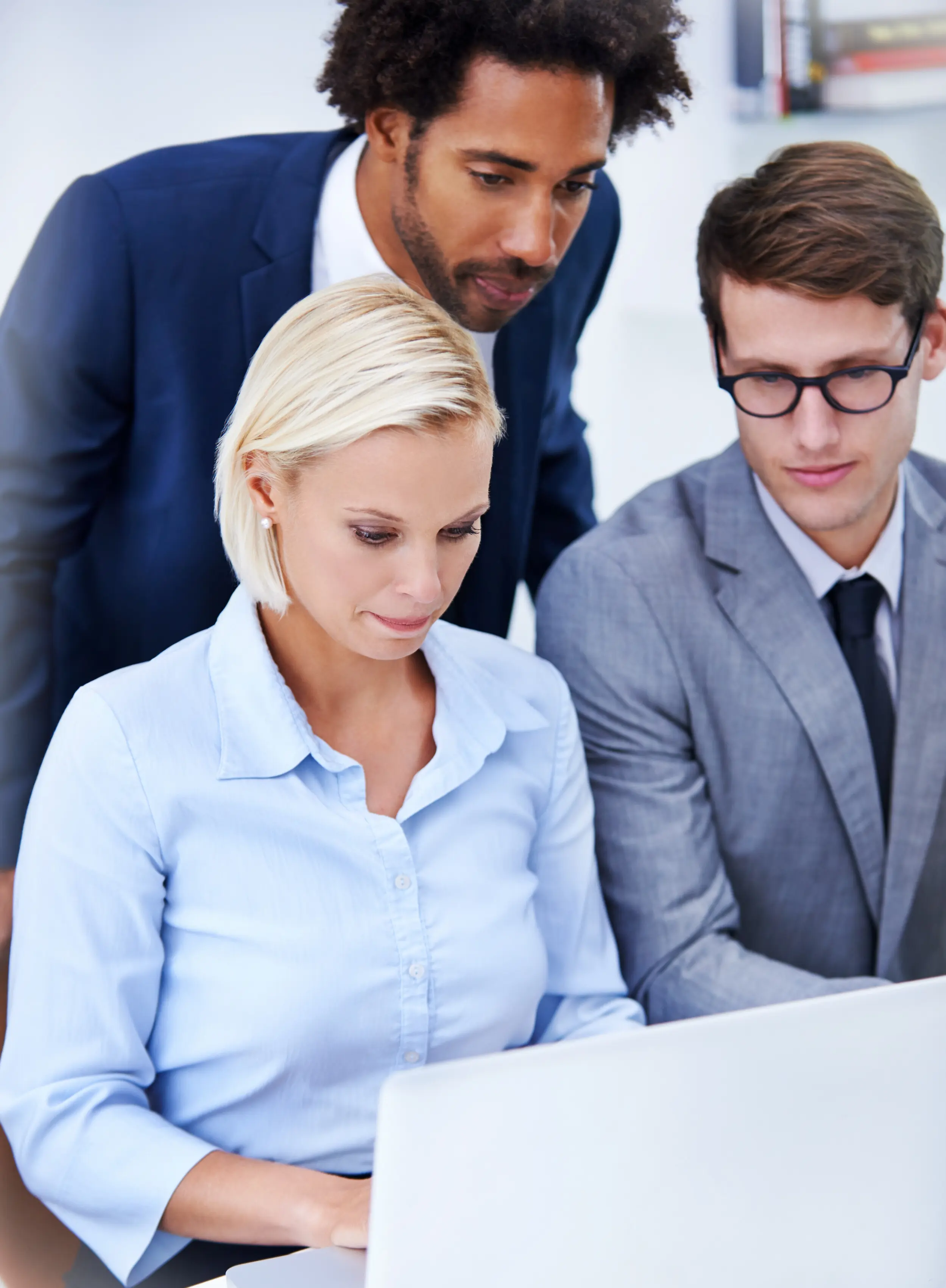 Team assistance or a laptop in an office for typing support, or a manager at a table for feedback; men, women, or tech in an agency for a business plan and collaboration at a computer for discussion or a performance review.